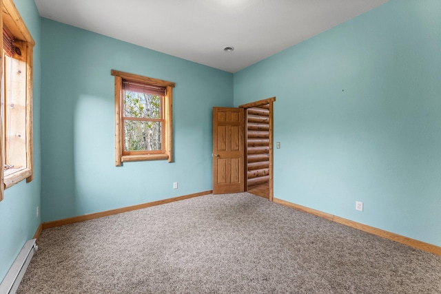 carpeted spare room featuring baseboards and a baseboard radiator