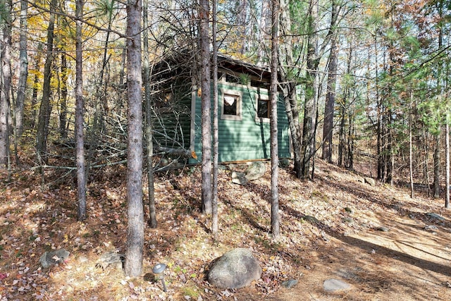 view of outbuilding featuring an outbuilding and a wooded view