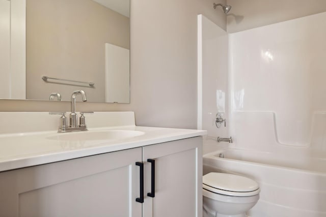 bathroom with vanity, toilet, and shower / bathing tub combination