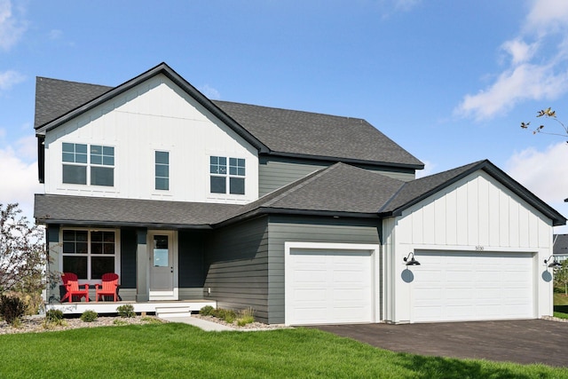 view of front of home with driveway, board and batten siding, covered porch, and an attached garage