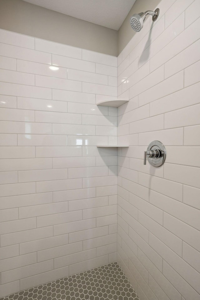 full bath with a tile shower