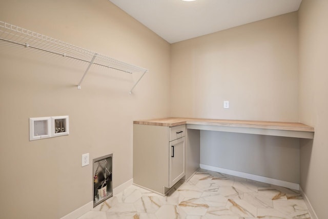 laundry room featuring washer hookup, baseboards, and marble finish floor