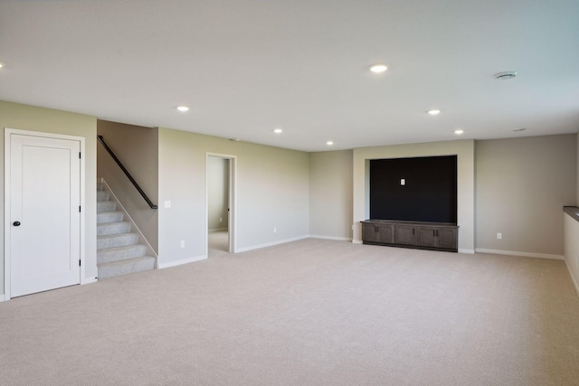 below grade area with stairway, carpet flooring, recessed lighting, and baseboards