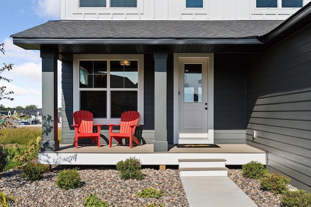 doorway to property with a porch, board and batten siding, and a shingled roof