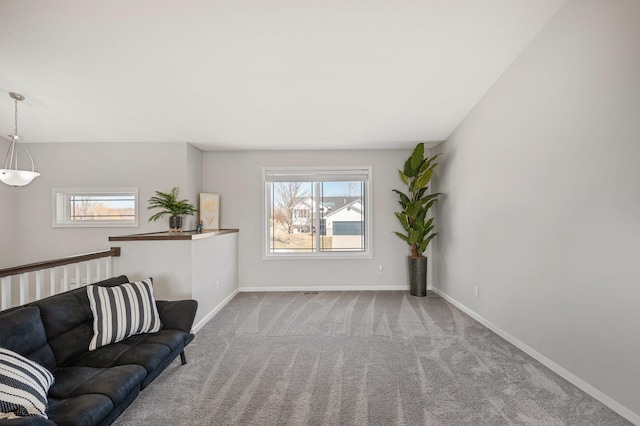 unfurnished living room featuring carpet flooring and baseboards