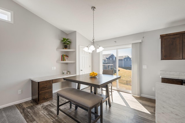 dining area with baseboards, lofted ceiling, a chandelier, and dark wood finished floors