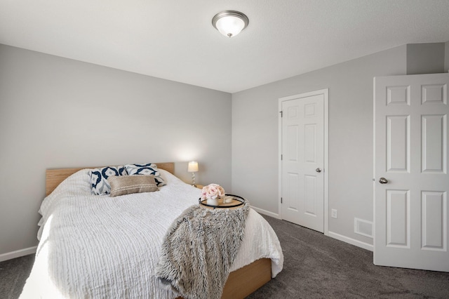 bedroom featuring visible vents, baseboards, and dark colored carpet