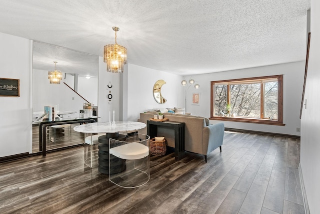 dining room with a chandelier, dark wood finished floors, a textured ceiling, and baseboards