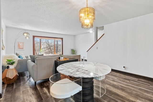 dining area with dark wood finished floors, a chandelier, a textured ceiling, and stairs