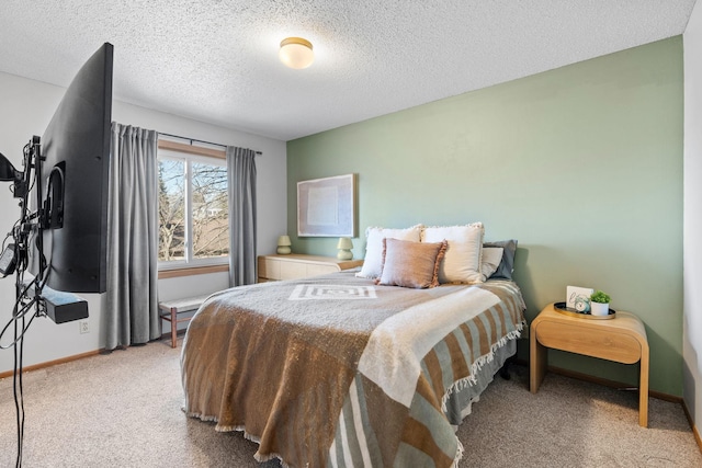 bedroom featuring light carpet, a textured ceiling, and baseboards