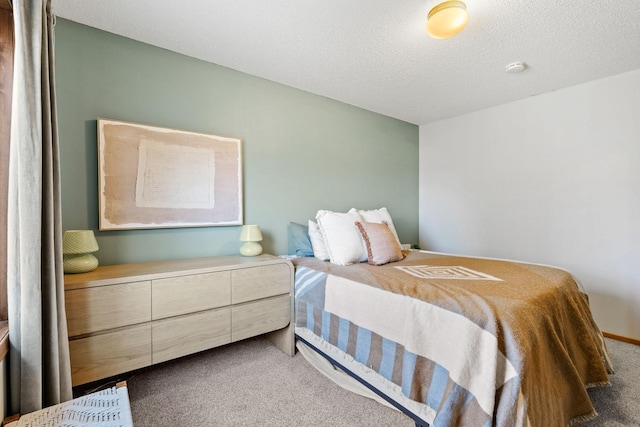 bedroom with carpet floors and a textured ceiling