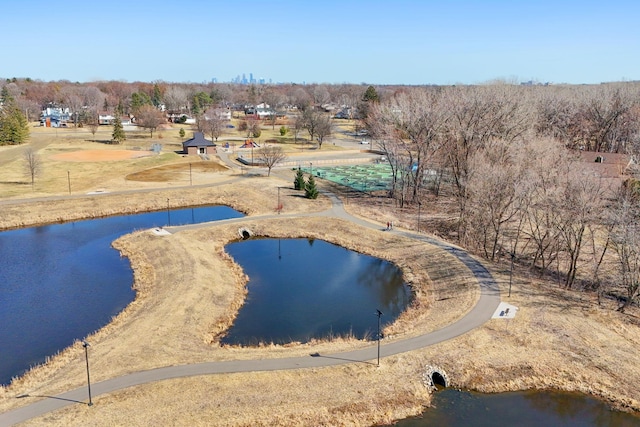 drone / aerial view of a large body of water and a tree filled landscape
