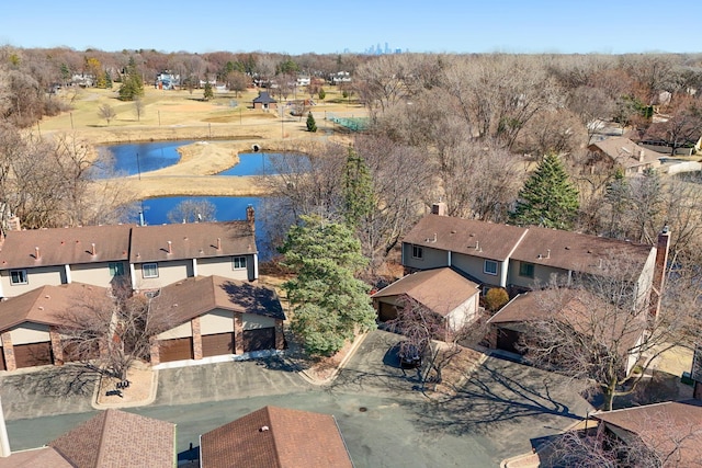 aerial view of property and surrounding area featuring a large body of water and nearby suburban area