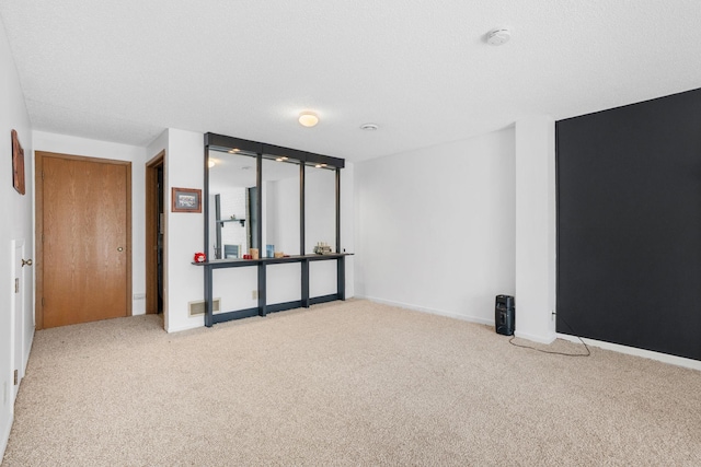 carpeted spare room with baseboards