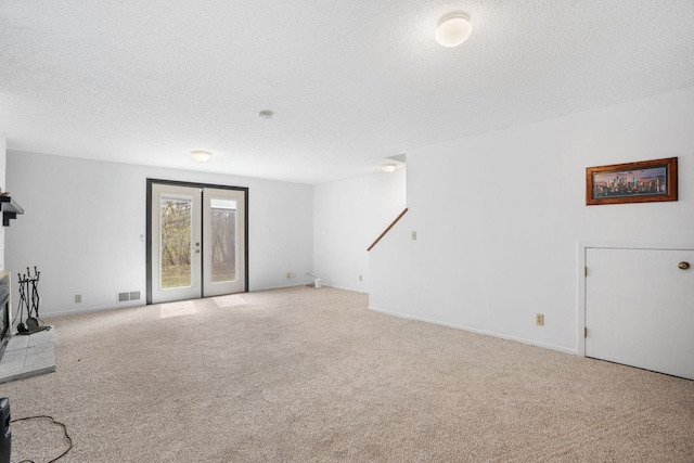 basement featuring a textured ceiling, carpet floors, and baseboards