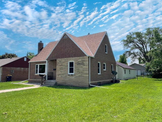 421 Van Dusen St, Springfield, MN 56087 - view of front facade featuring a chimney, a front yard, brick siding, and roof with shingles