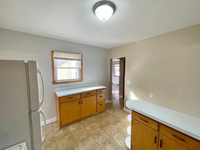 421 Van Dusen St, Springfield, MN 56087 - kitchen with freestanding refrigerator, light countertops, plenty of natural light, and baseboards