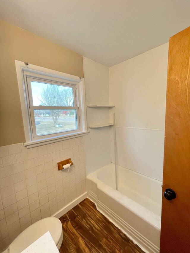 421 Van Dusen St, Springfield, MN 56087 - bathroom with toilet, wood finished floors, and a tub to relax in