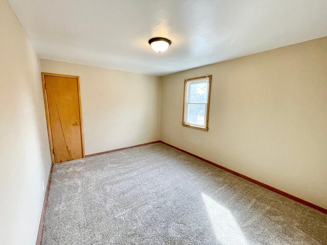 421 Van Dusen St, Springfield, MN 56087 - carpeted empty room with baseboards