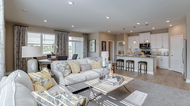 living room with recessed lighting and light wood-type flooring