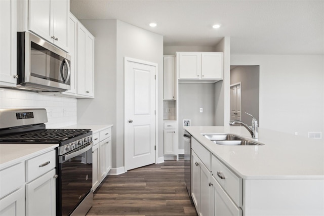 kitchen featuring a sink, dark wood finished floors, white cabinetry, appliances with stainless steel finishes, and light countertops