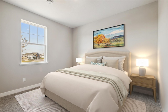 bedroom featuring carpet flooring and baseboards