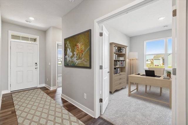 foyer with wood finished floors and baseboards