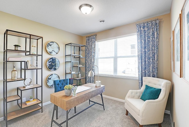 carpeted office featuring visible vents, baseboards, and a textured ceiling