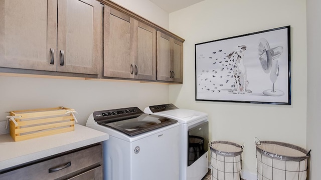 laundry area with cabinet space and separate washer and dryer