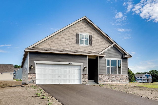 craftsman-style home featuring stone siding and driveway