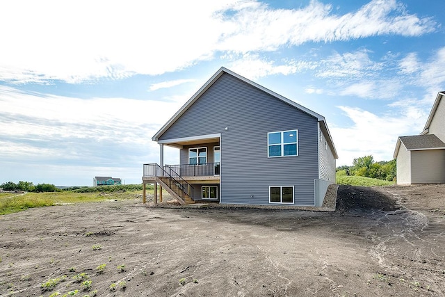 back of house with stairs