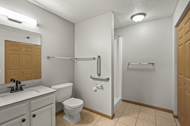 bathroom with tile patterned flooring, a shower stall, toilet, and vanity