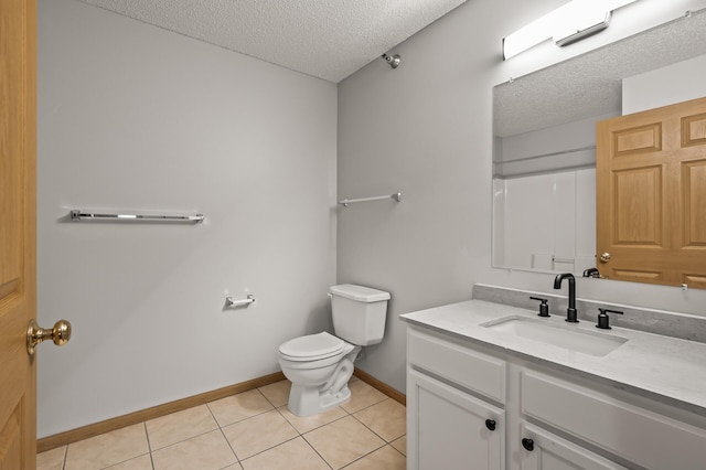 full bath with tile patterned flooring, a textured ceiling, toilet, and vanity