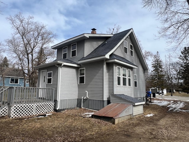 1126 Linden Ln, Detroit Lakes, MN 56501 - back of property with a chimney, a wooden deck, and a shingled roof