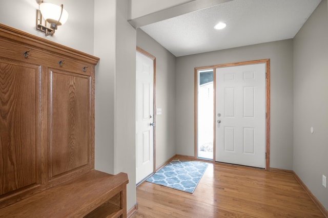 entrance foyer with light wood-style floors and baseboards