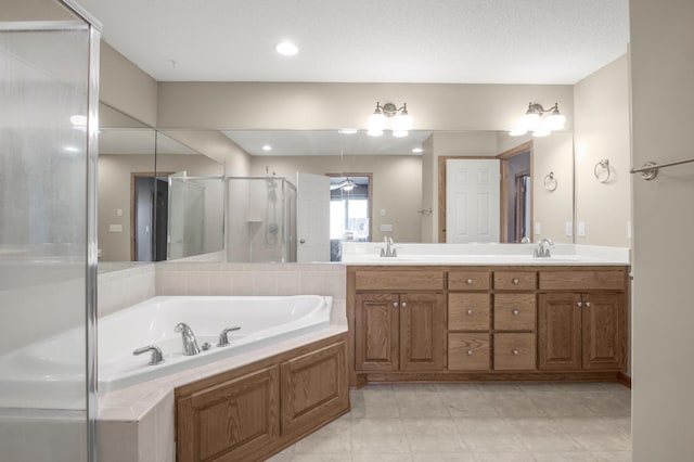 bathroom with a sink, a garden tub, double vanity, and a shower stall