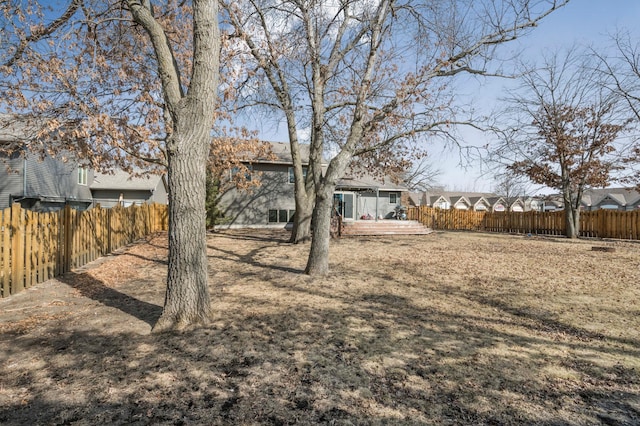 view of yard featuring a wooden deck and fence private yard