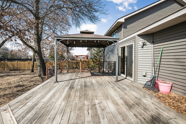 wooden deck featuring a gazebo and fence