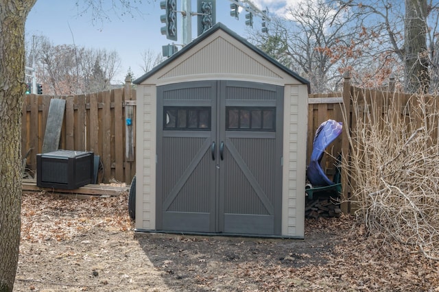 view of shed with a fenced backyard