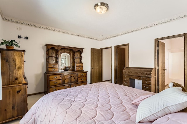 bedroom with light colored carpet and baseboards