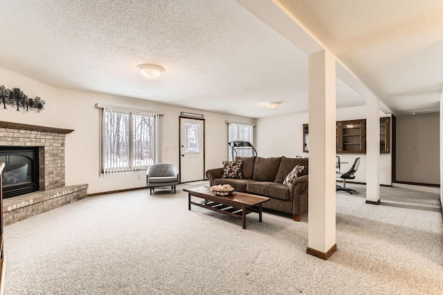 carpeted living area featuring a fireplace, a textured ceiling, and baseboards