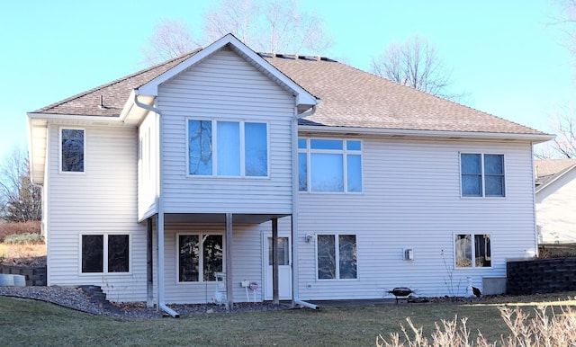 rear view of property featuring roof with shingles