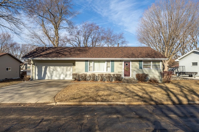 ranch-style house featuring a garage, roof with shingles, and concrete driveway