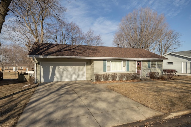 ranch-style house featuring an attached garage and driveway