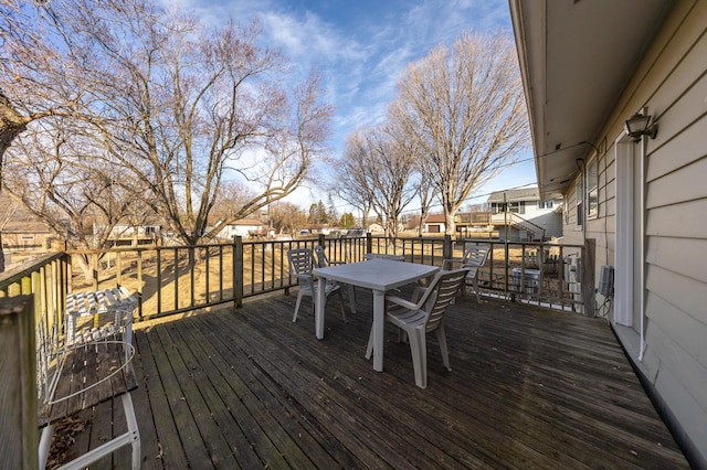 deck with outdoor dining space and a residential view