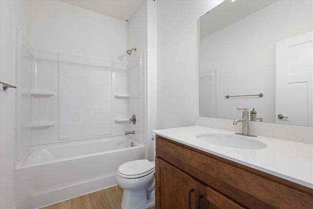 full bathroom with shower / bath combination, toilet, wood finished floors, and vanity