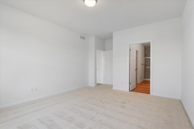 unfurnished bedroom featuring visible vents, baseboards, and carpet floors