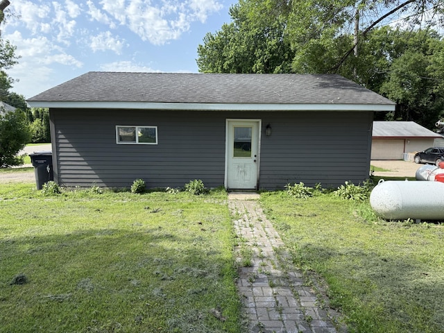 902 Pacific Ave, Kerkhoven, MN 56252 - view of front facade featuring a front yard and roof with shingles