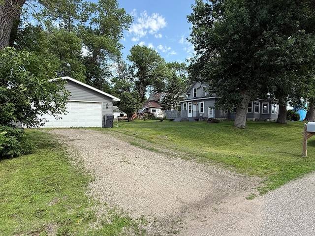 902 Pacific Ave, Kerkhoven, MN 56252 - view of front of home with a front yard and a detached garage