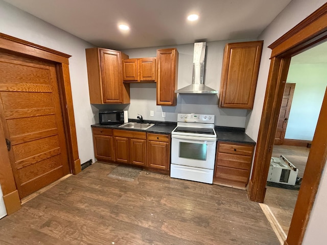 902 Pacific Ave, Kerkhoven, MN 56252 - kitchen featuring white range with electric cooktop, wall chimney exhaust hood, dark countertops, dark wood finished floors, and brown cabinets